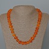 Collier en cristal orange teinté à l'ambre, perle facettée, diamètre 12×8 mm+-, longueur 50 cm+