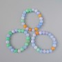 Bracelet assorti (pres.) billes lisses, diamètre 10 mm +/-, longueur 18 cm +/- (élastique)