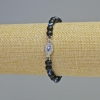 Bracelet en shungite — boule lisse, diamètre environ 6 mm, longueur 18 cm ±, élastique, avec inserts « Œil »