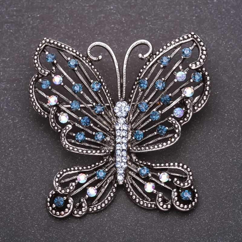 Broche papillon avec strass bleus, 53×54 mm, métal gris